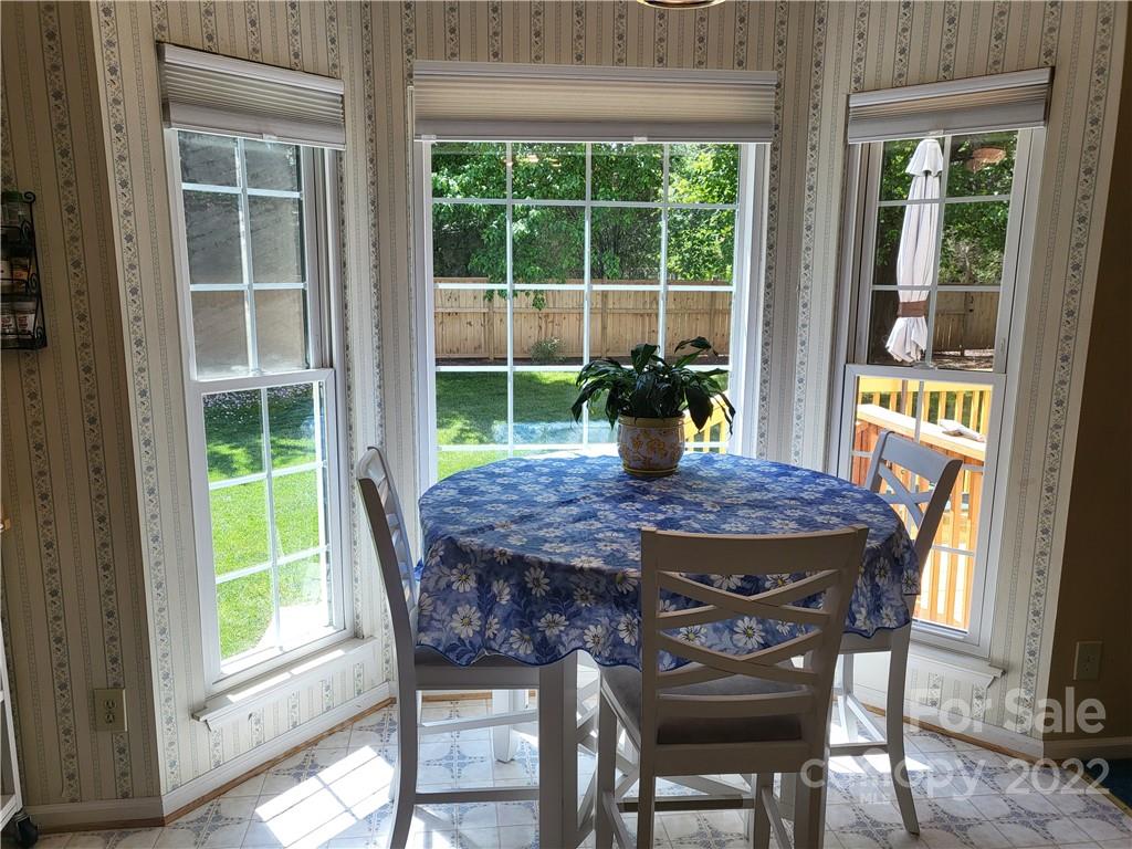 9216 Torrence Crossing Drive Huntersville, NC 28078 - Photo 22 of 34 a dining table with chairs and window
