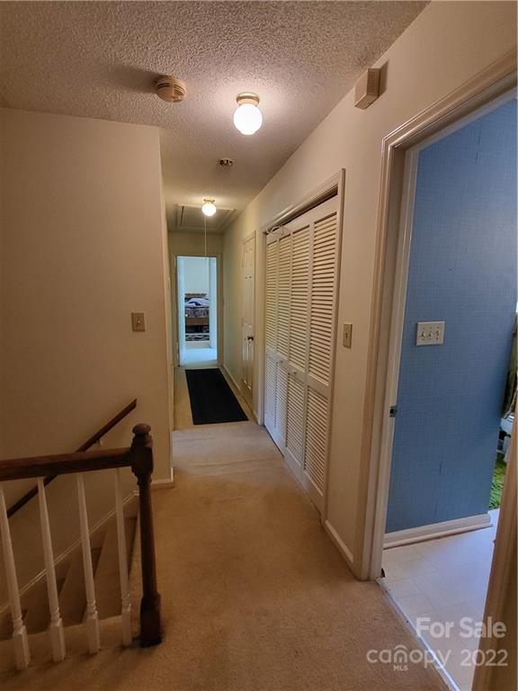 9216 Torrence Crossing Drive Huntersville, NC 28078 - Photo 25 of 34 a view of a hallway with wooden floor