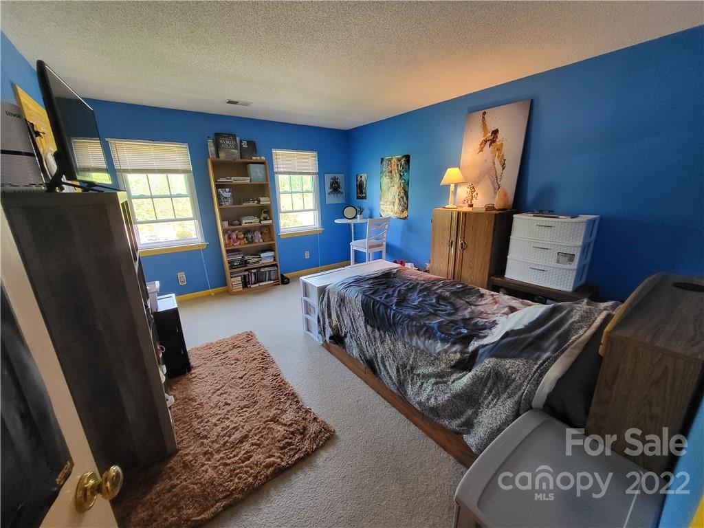 9216 Torrence Crossing Drive Huntersville, NC 28078 - Photo 27 of 34 a bedroom with a large bed and a window