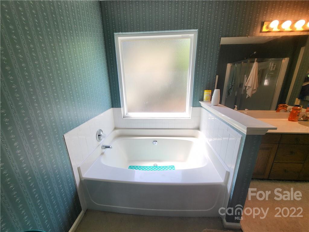 9216 Torrence Crossing Drive Huntersville, NC 28078 - Photo 29 of 34 a bathroom with a bathtub