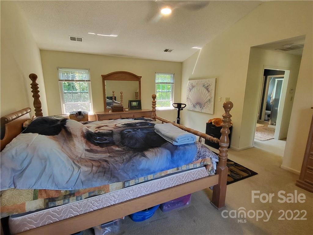9216 Torrence Crossing Drive Huntersville, NC 28078 - Photo 33 of 34 a bed room with a bed window and dresser