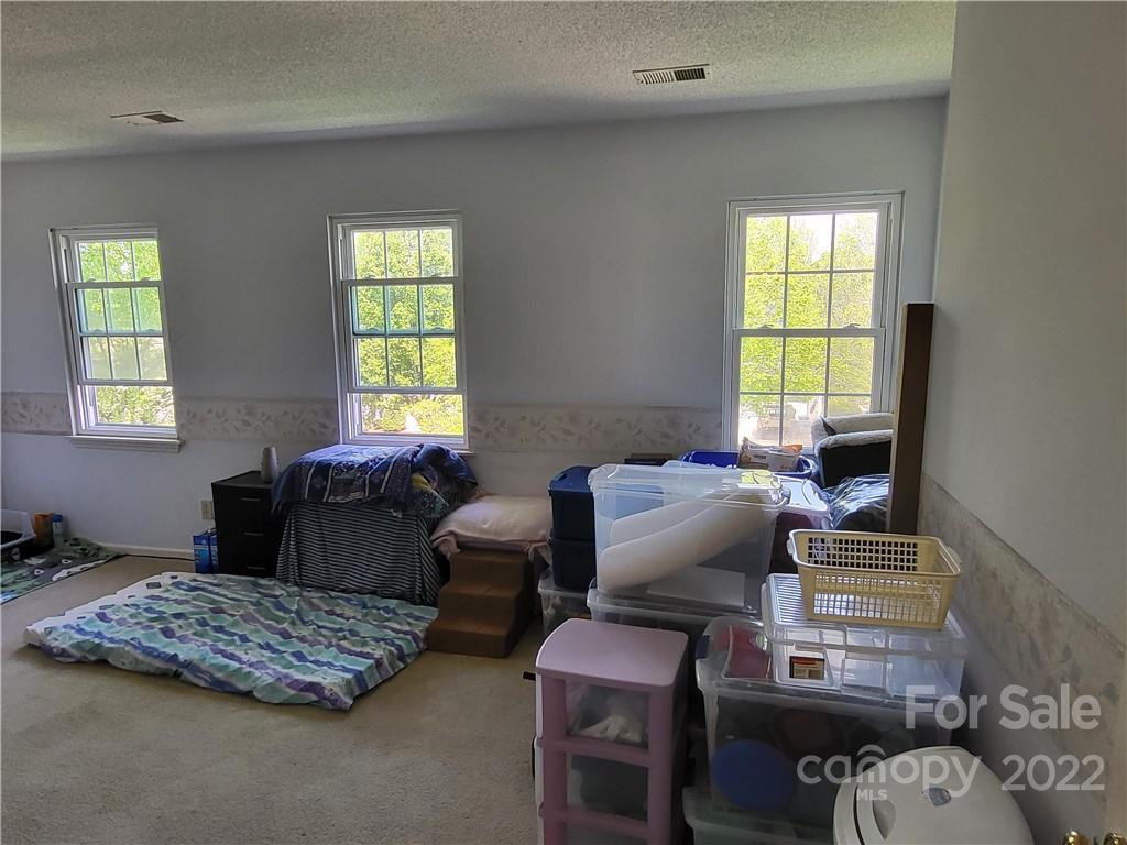 9216 Torrence Crossing Drive Huntersville, NC 28078 - Photo 34 of 34 a bedroom with furniture and a window