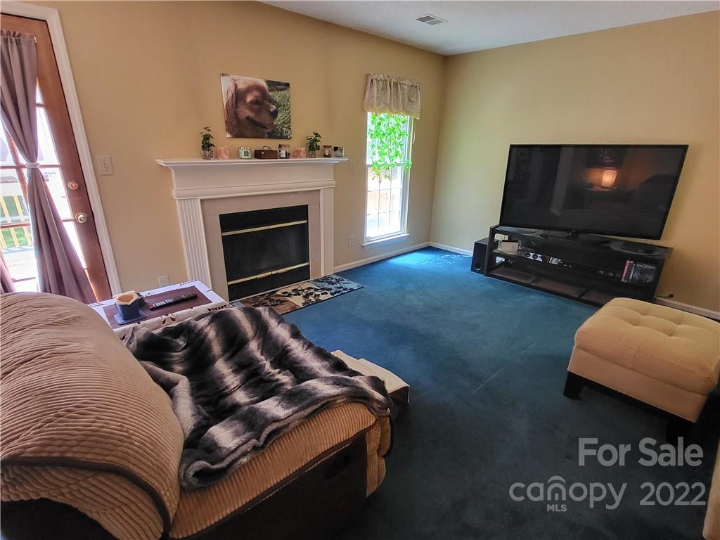 9216 Torrence Crossing Drive Huntersville, NC 28078 - Photo 10 of 34 a living room with furniture and a flat screen tv