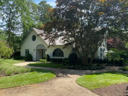 a front view of house with yard and green space