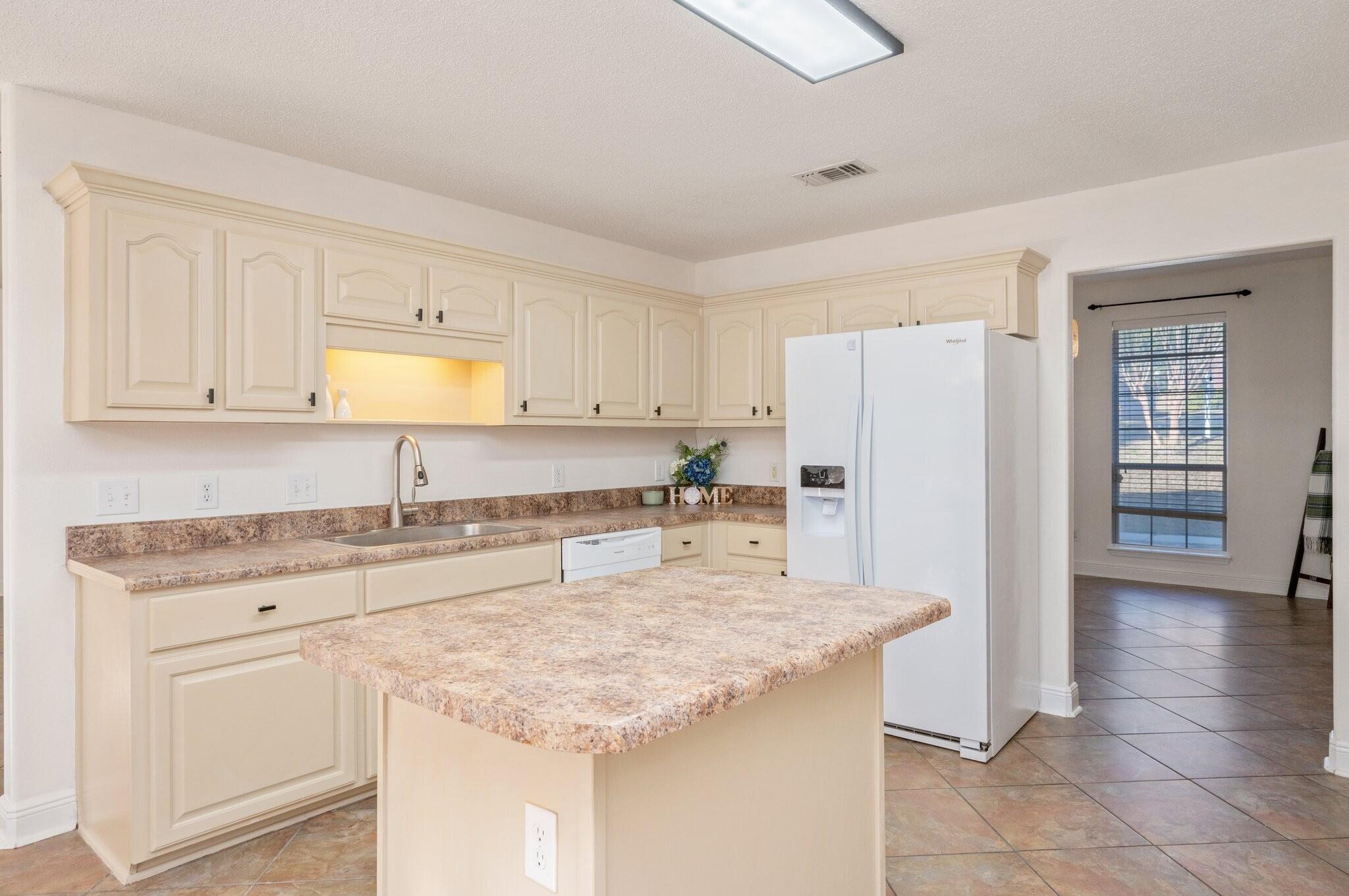 416 Swift Fox Run Crestview, FL 32536 - Photo 11 of 32 a kitchen with granite countertop a sink a stove and refrigerator
