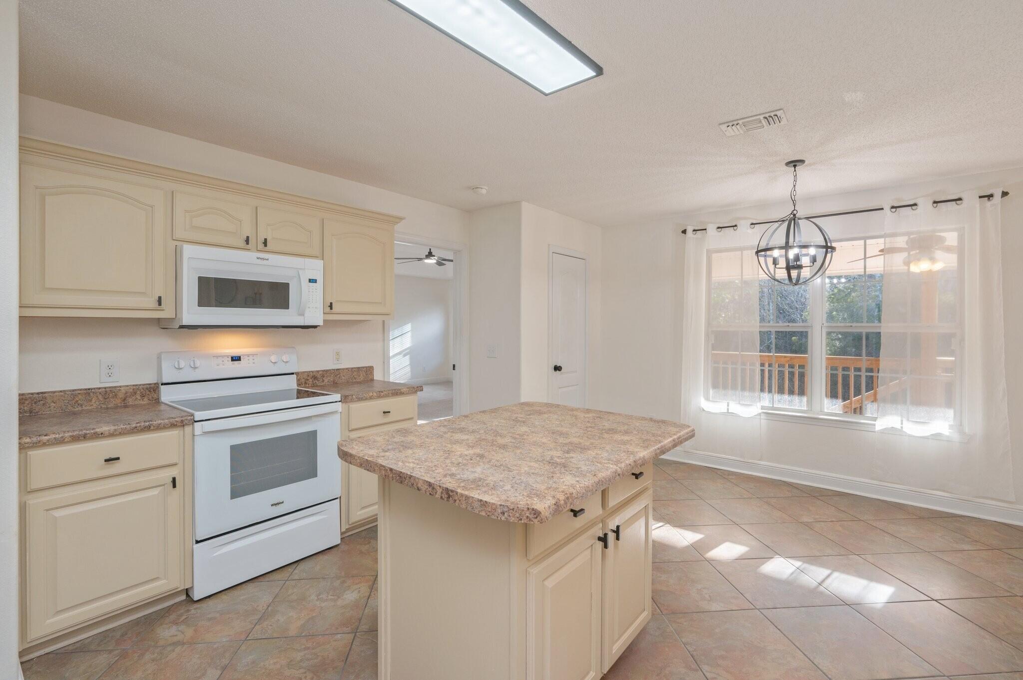 416 Swift Fox Run Crestview, FL 32536 - Photo 12 of 32 a kitchen with a stove and a sink