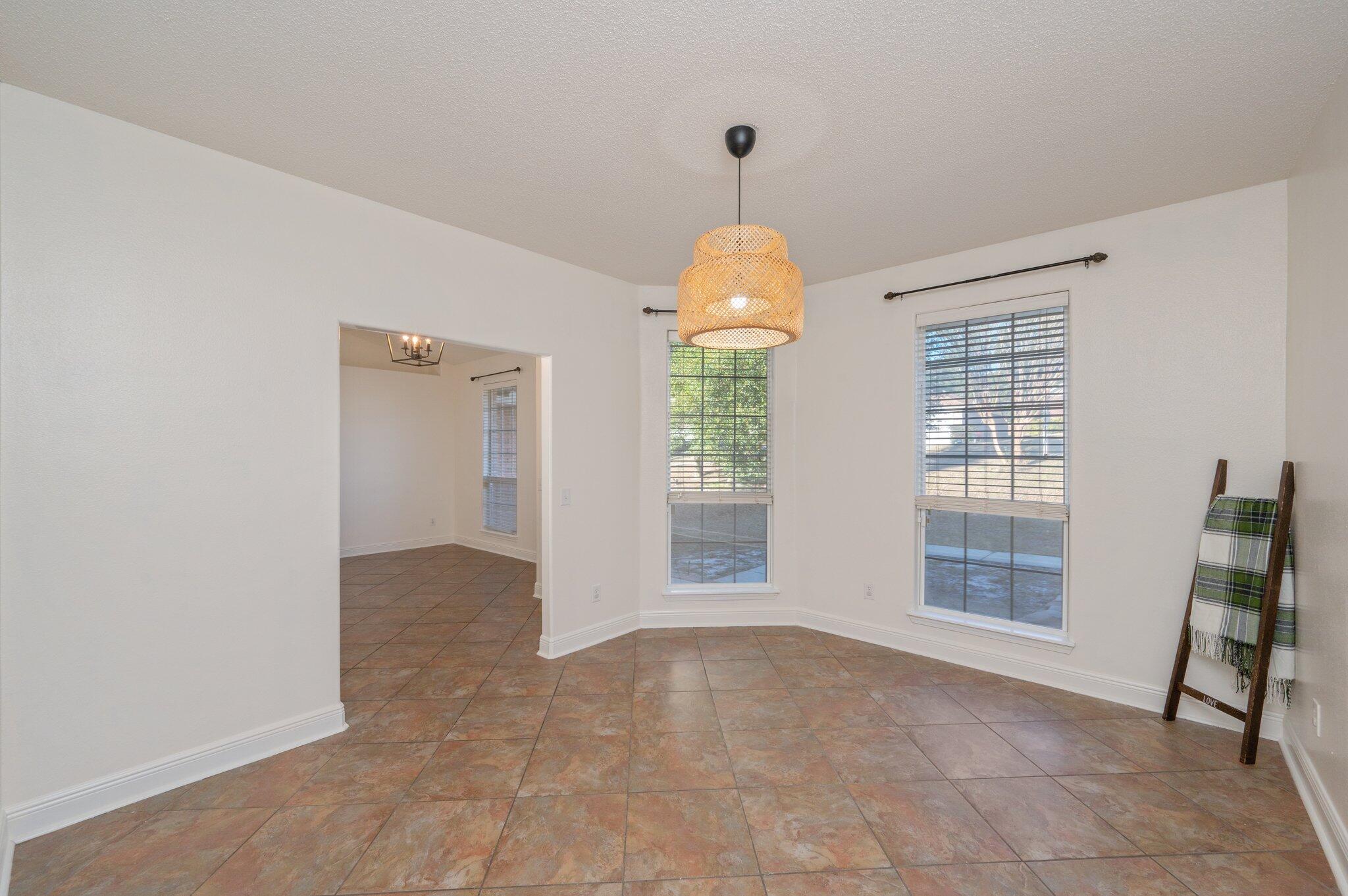416 Swift Fox Run Crestview, FL 32536 - Photo 14 of 32 an empty room with chandelier fan and windows