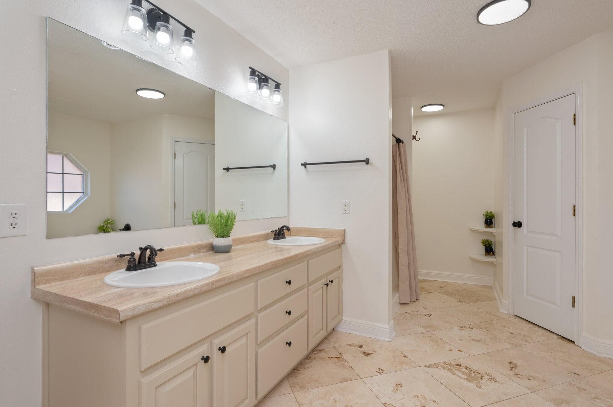 416 Swift Fox Run Crestview, FL 32536 - Photo 16 of 32 a bathroom with a double vanity sink a mirror and a shower
