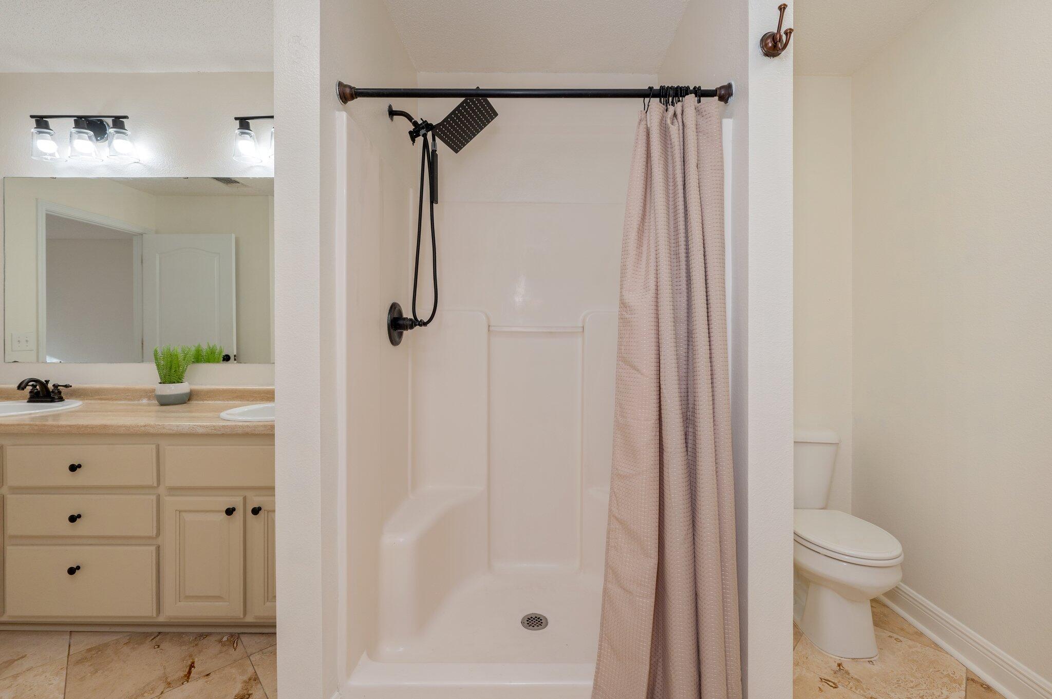 416 Swift Fox Run Crestview, FL 32536 - Photo 18 of 32 a bathroom with a shower sink vanity and toilet