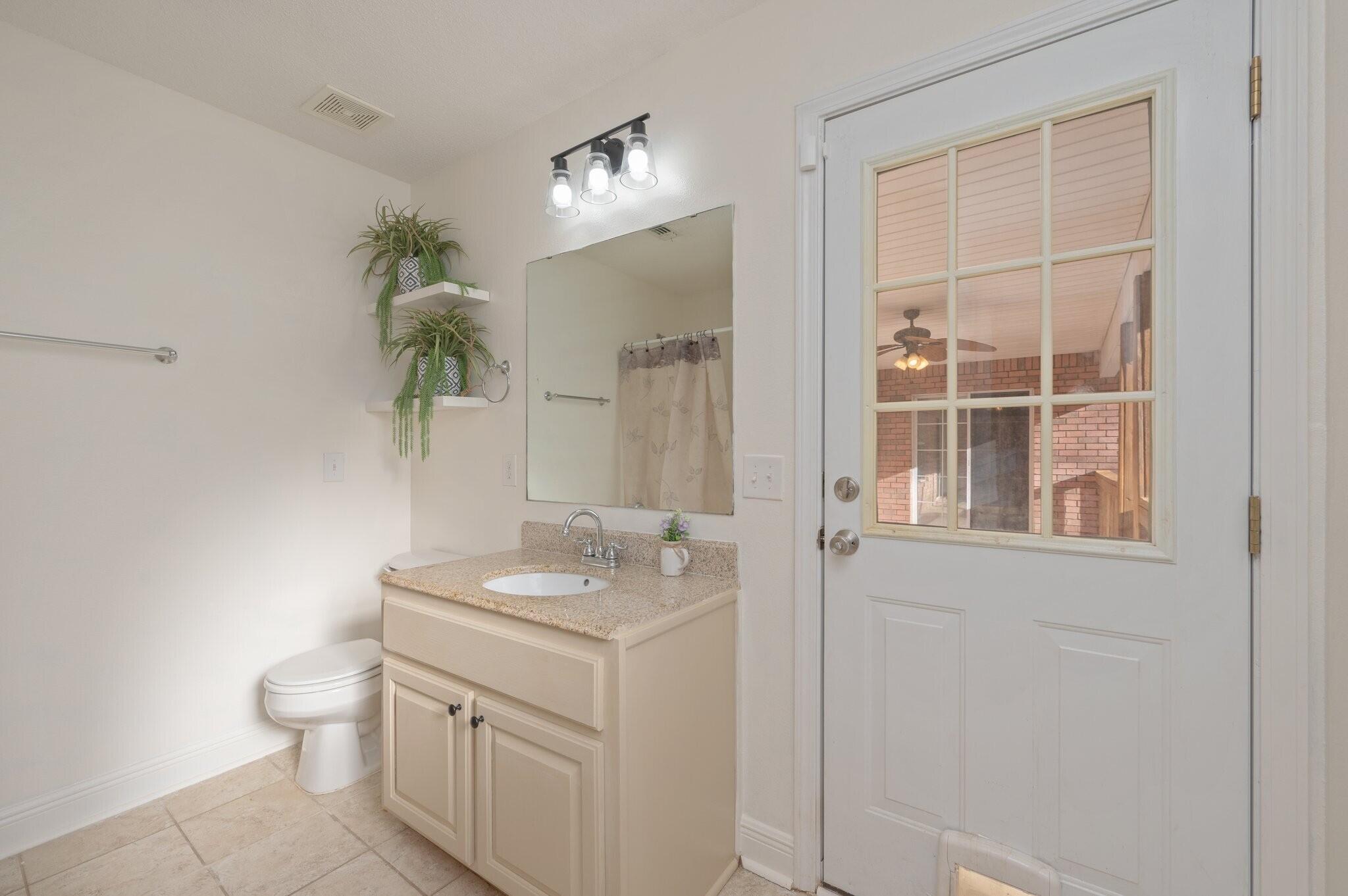 416 Swift Fox Run Crestview, FL 32536 - Photo 21 of 32 a bathroom with a granite countertop sink a toilet and a mirror