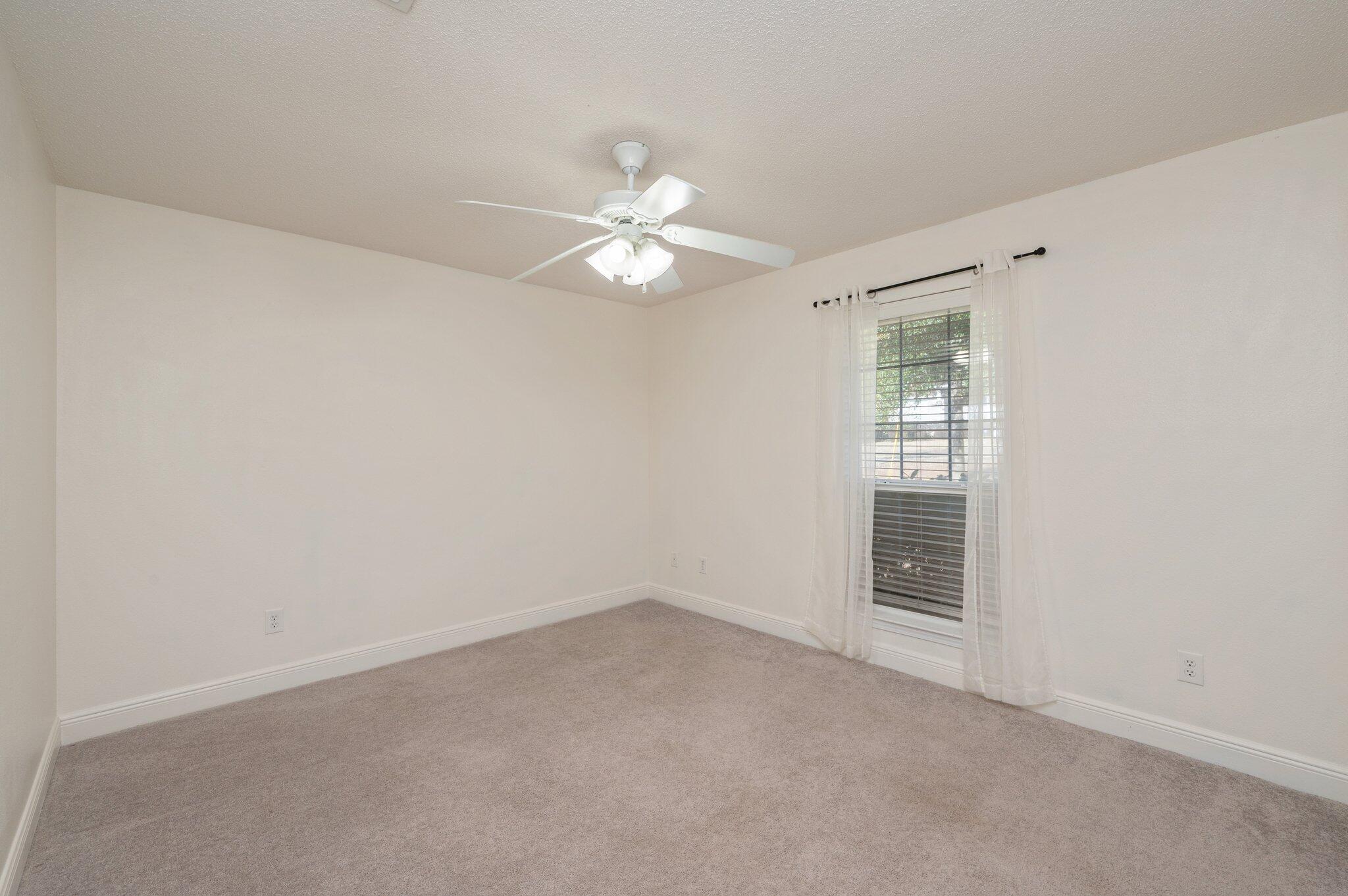 416 Swift Fox Run Crestview, FL 32536 - Photo 23 of 32 an empty room with windows and fan