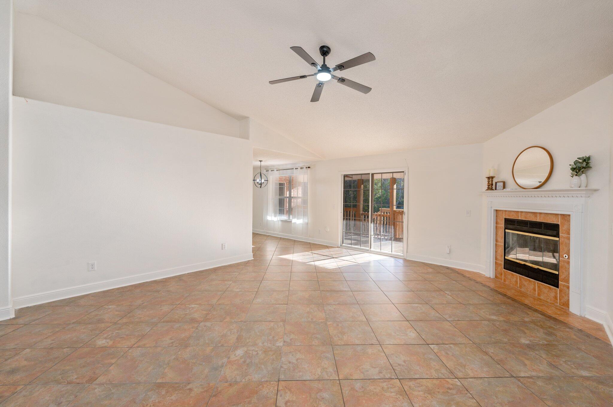 416 Swift Fox Run Crestview, FL 32536 - Photo 5 of 32 a view of an empty room with a ceiling fan and windows
