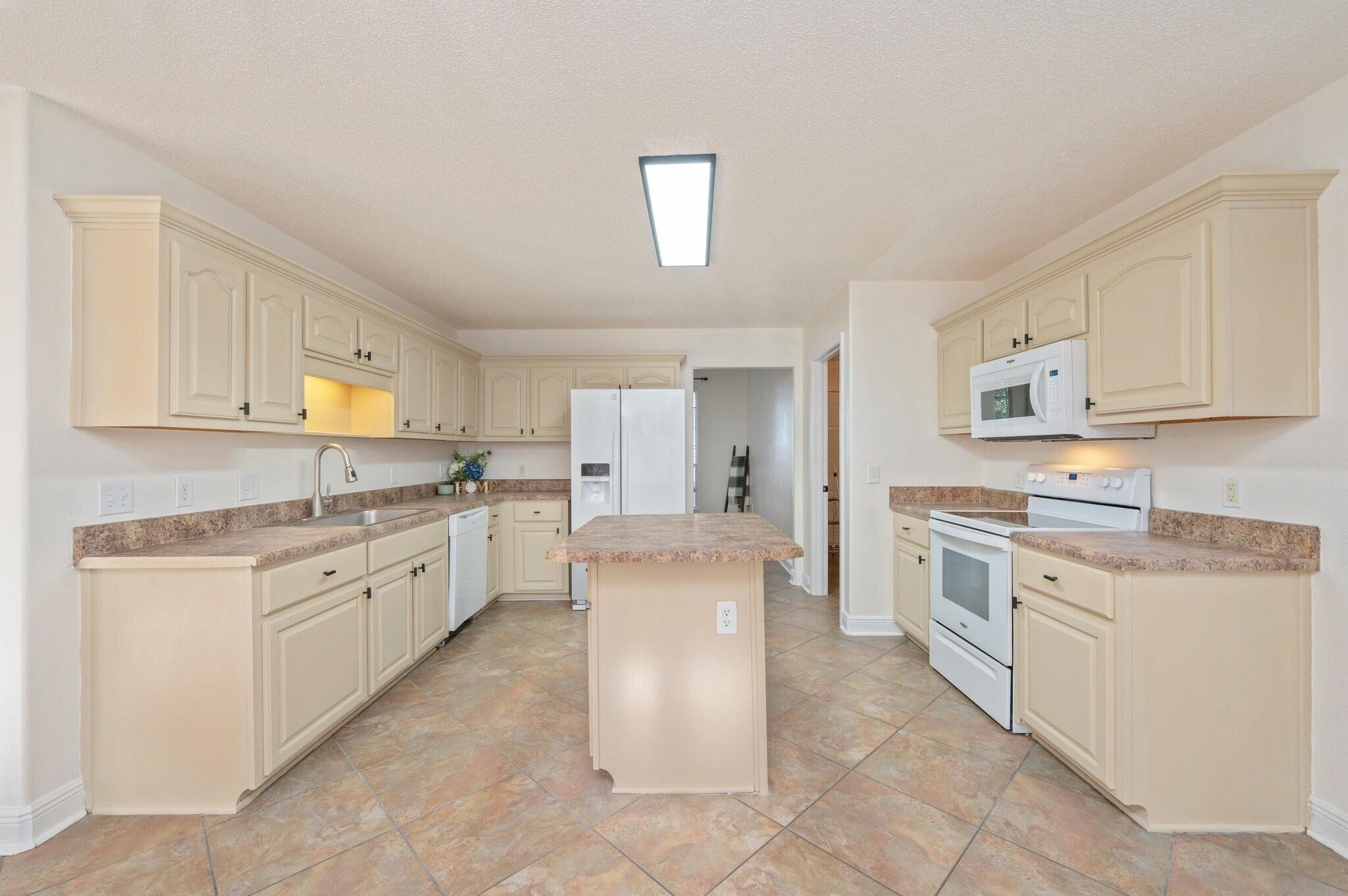 416 Swift Fox Run Crestview, FL 32536 - Photo 10 of 32 a kitchen with granite countertop cabinets and white appliances