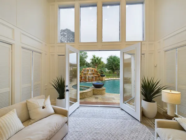 a living room with furniture and large windows