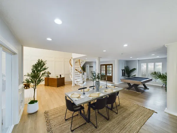 a view of a dining room with furniture and wooden floor