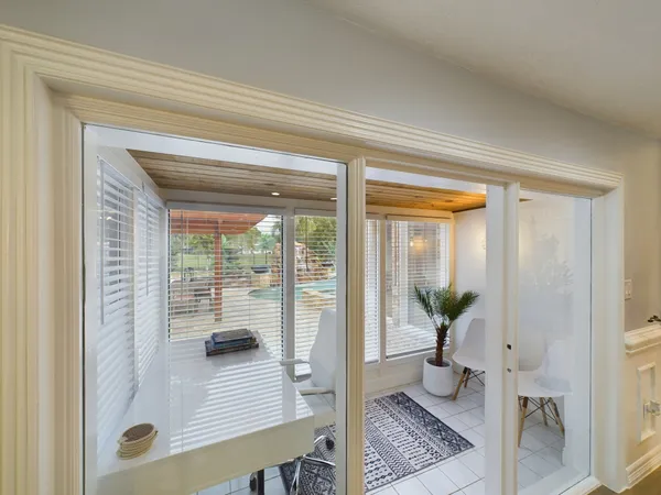 a kitchen with a dining table chairs and wooden floor