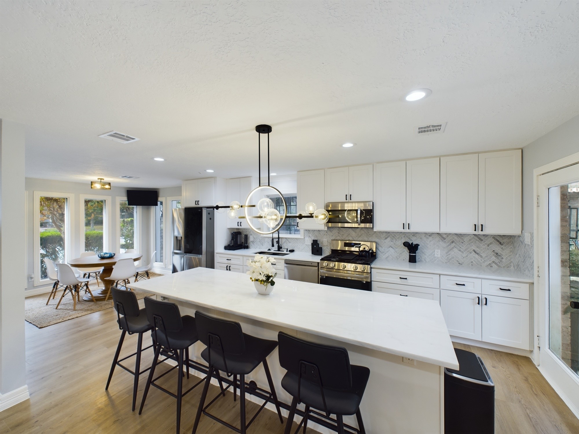 7702 Antoine Drive Houston, TX 77088 - Photo 14 of 50 Spectacular Kitchen with Large Marble Slab Central Island, Countertops and Herringbone Backsplash