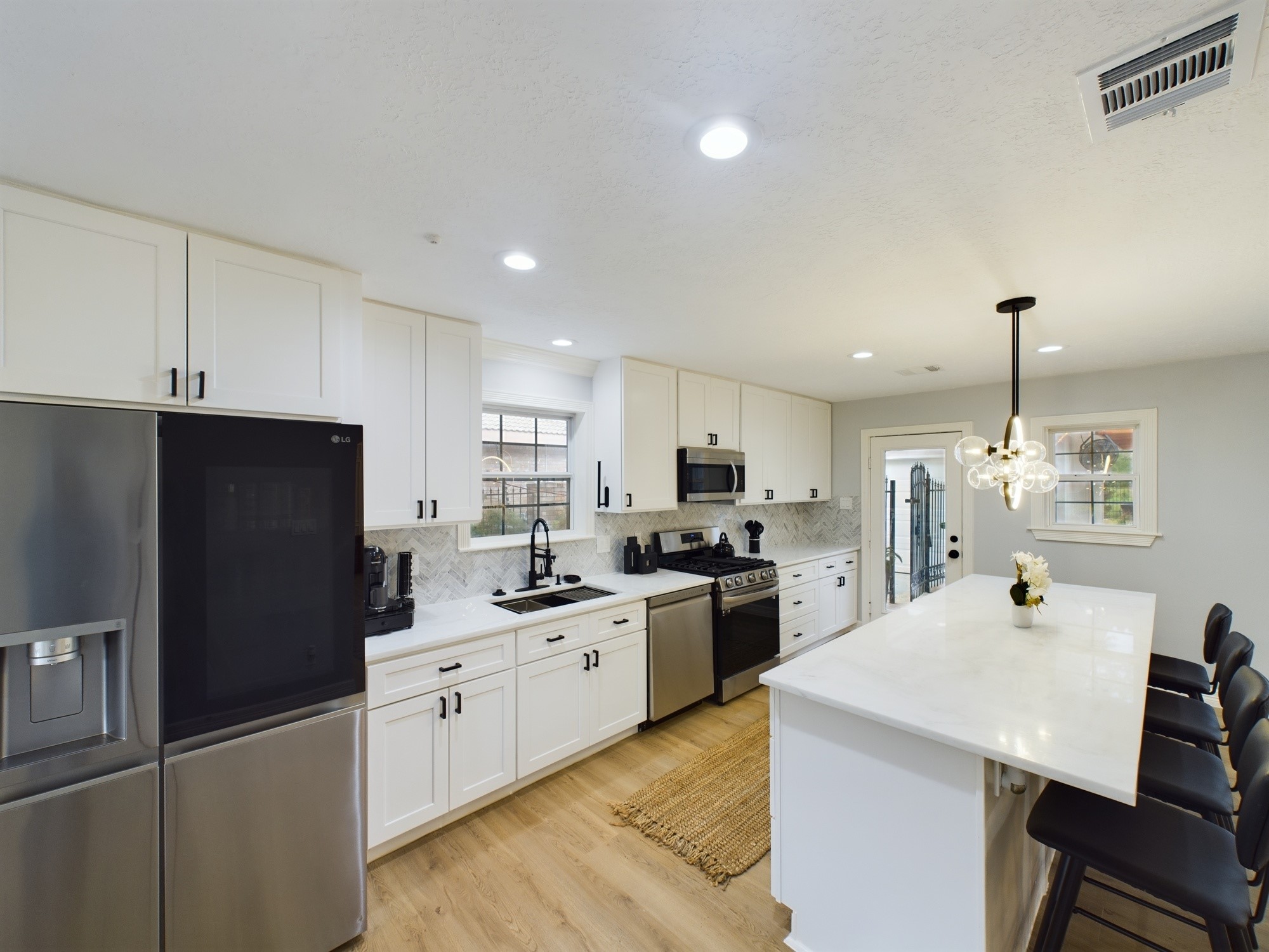 7702 Antoine Drive Houston, TX 77088 - Photo 15 of 50 SS Appliances include Quad-Door Refrigerator, Dishwasher, Microwave and Four Burner Gas Range w/Griddle