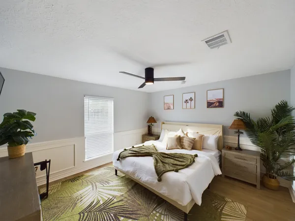 a bedroom with a bed and a lamp