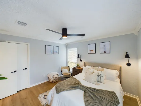 a bedroom with a bed and glass windows