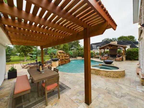 a swimming pool with barbeque oven in front of it