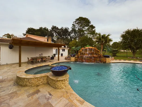 a outdoor living space with patio furniture and a fireplace