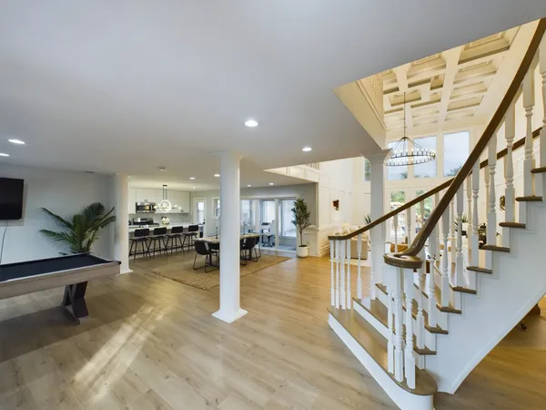 a living room with furniture a table and wooden floor