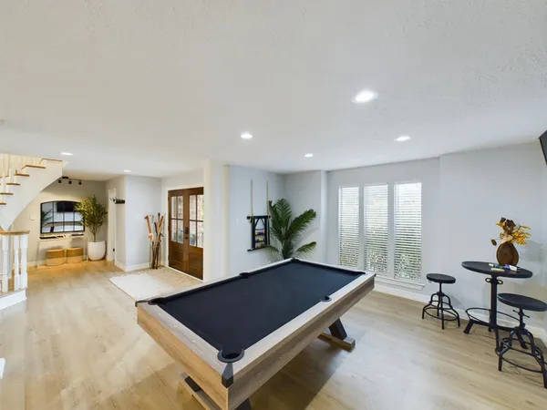 a living room with furniture a rug and potted plants