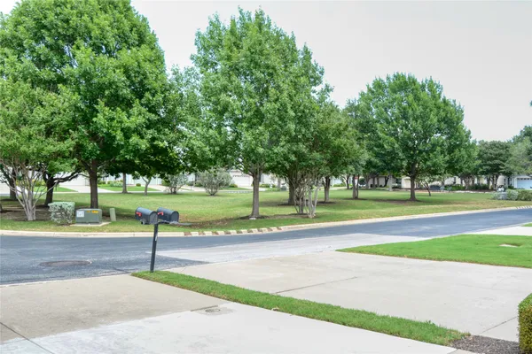 a front view of a house with a garden and yard