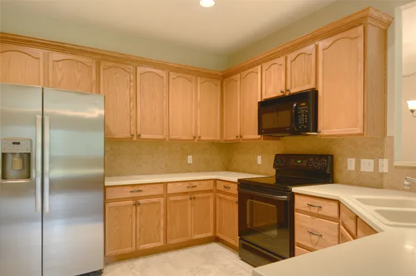 a view of a room with wooden floor and a ceiling fan