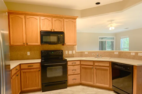 a kitchen with a refrigerator stove and sink