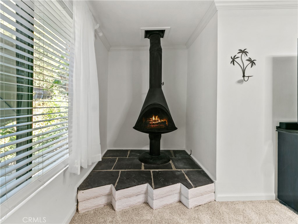 29501 Silverado Canyon Road Silverado, CA 92676 - Photo 14 of 49 How about this COOL fireplace in primary bedroom tucked away in the corner, (AI added fire)