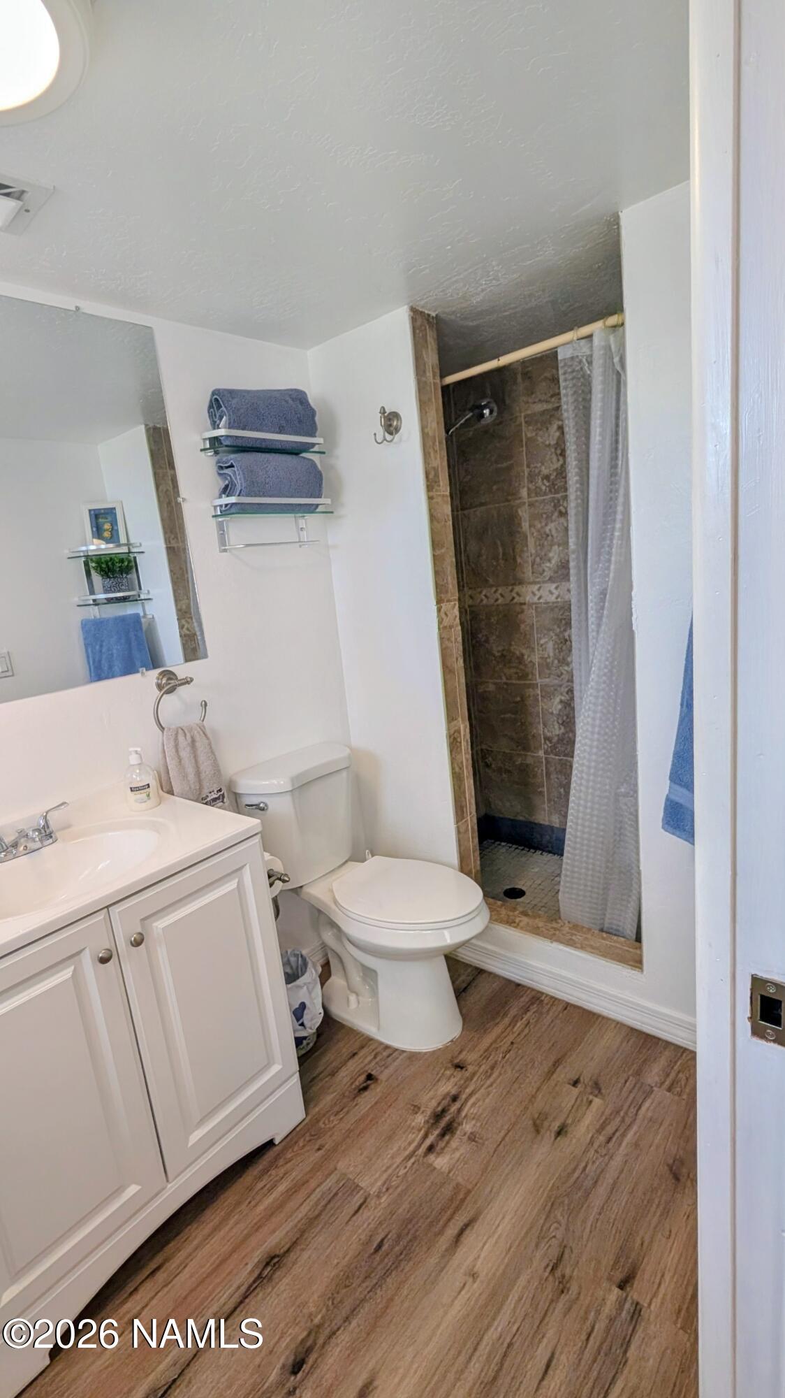 15702 Bonanza Loop Ehrenberg, AZ 85334 - Photo 12 of 13 a bathroom with a sink a toilet and shower