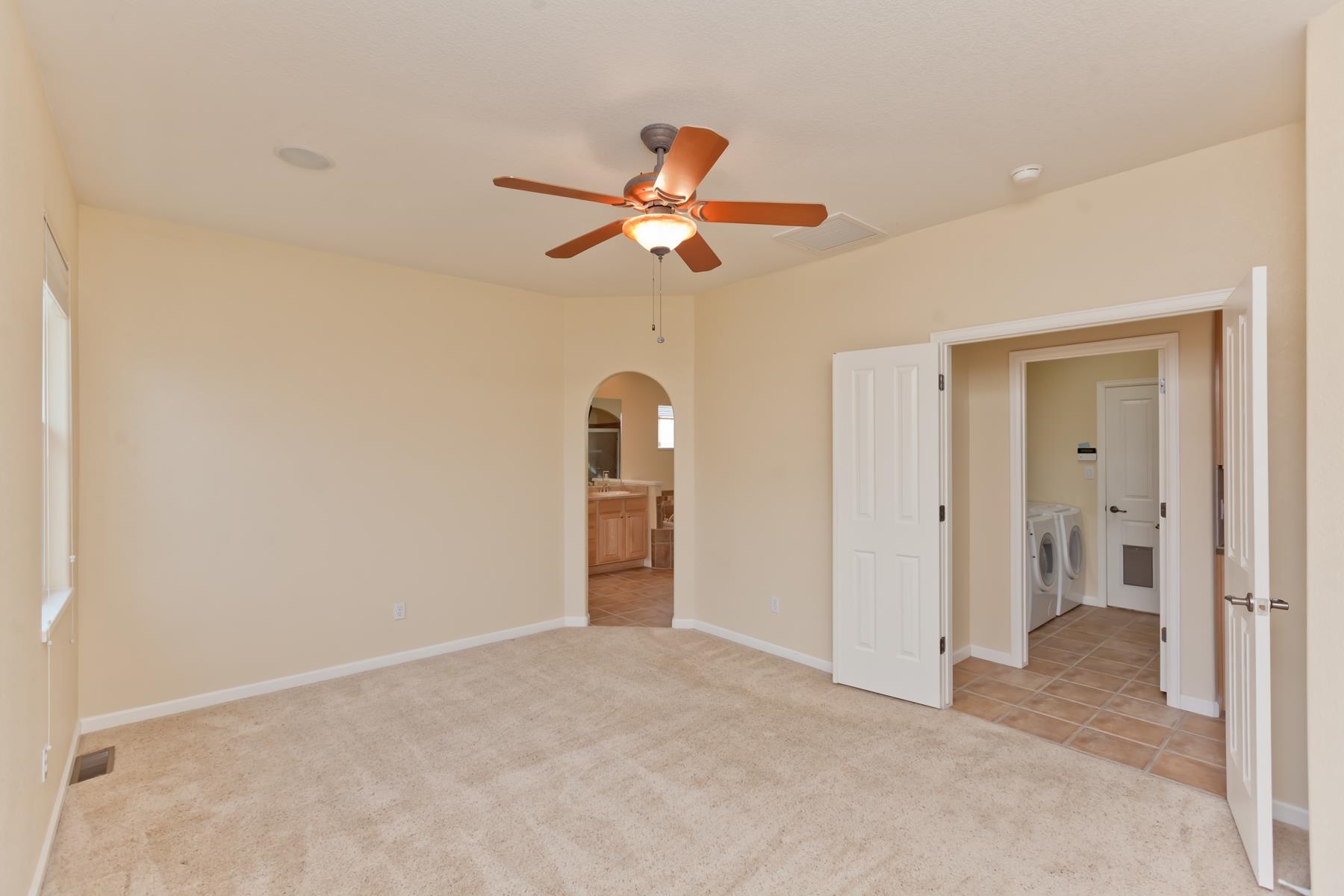 2433 Jack Creek Road Grand Junction, CO 81505 - Photo 15 of 41 a view of a room with a ceiling fan and a bathroom