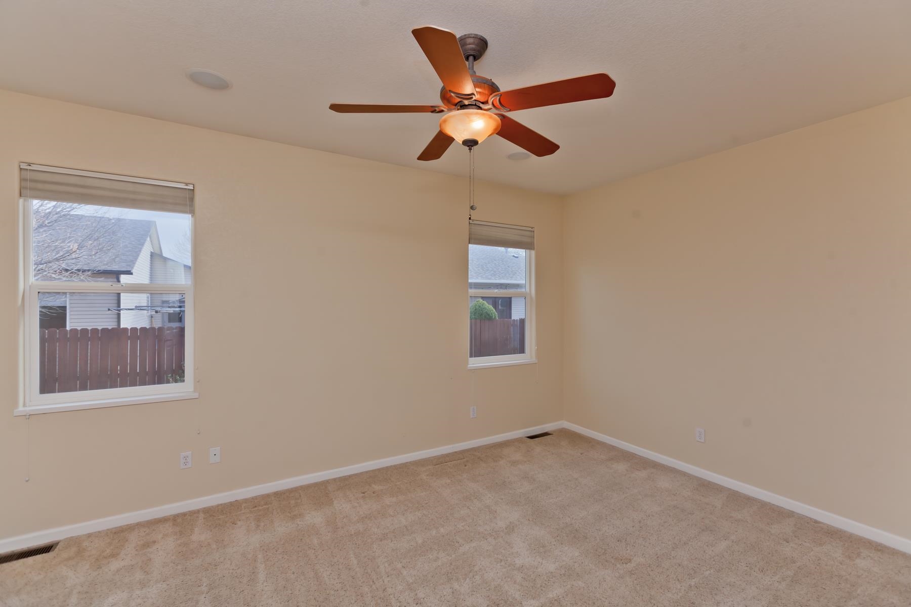 2433 Jack Creek Road Grand Junction, CO 81505 - Photo 16 of 41 an empty room with a window and a fan