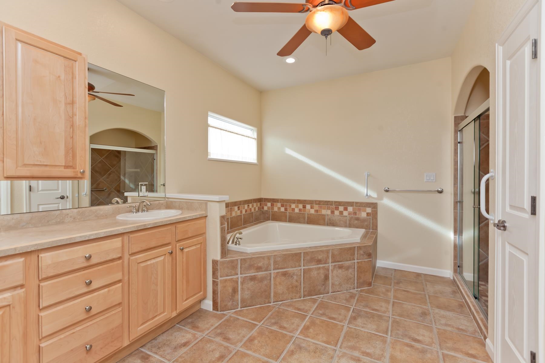 2433 Jack Creek Road Grand Junction, CO 81505 - Photo 18 of 41 a bathroom with a granite countertop sink a mirror and a bathtub