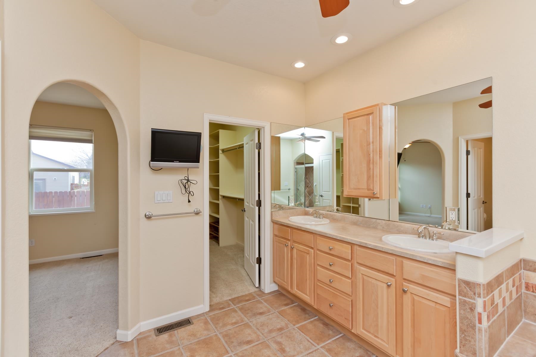 2433 Jack Creek Road Grand Junction, CO 81505 - Photo 19 of 41 a spacious bathroom with a double vanity sink and a mirror