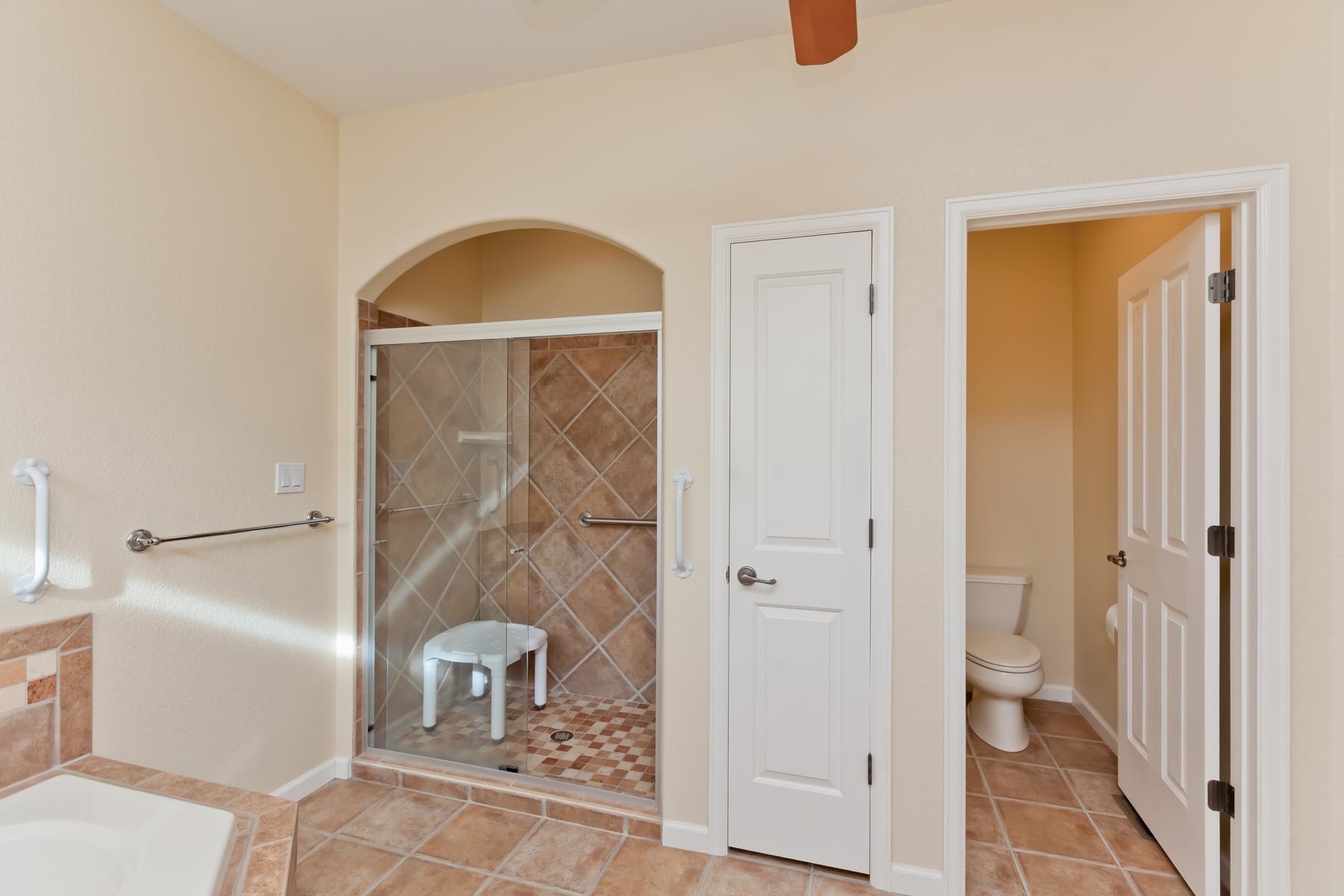 2433 Jack Creek Road Grand Junction, CO 81505 - Photo 20 of 41 a bathroom with a granite countertop shower a toilet and a sink