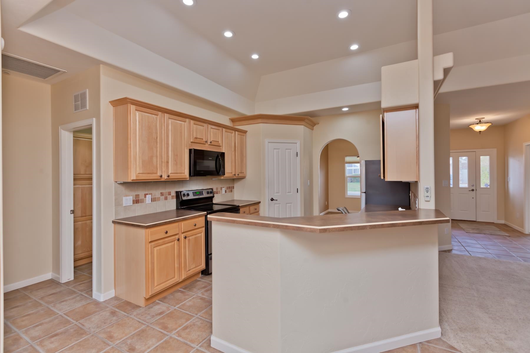 2433 Jack Creek Road Grand Junction, CO 81505 - Photo 2 of 41 a large kitchen with stainless steel appliances granite countertop a stove and a sink