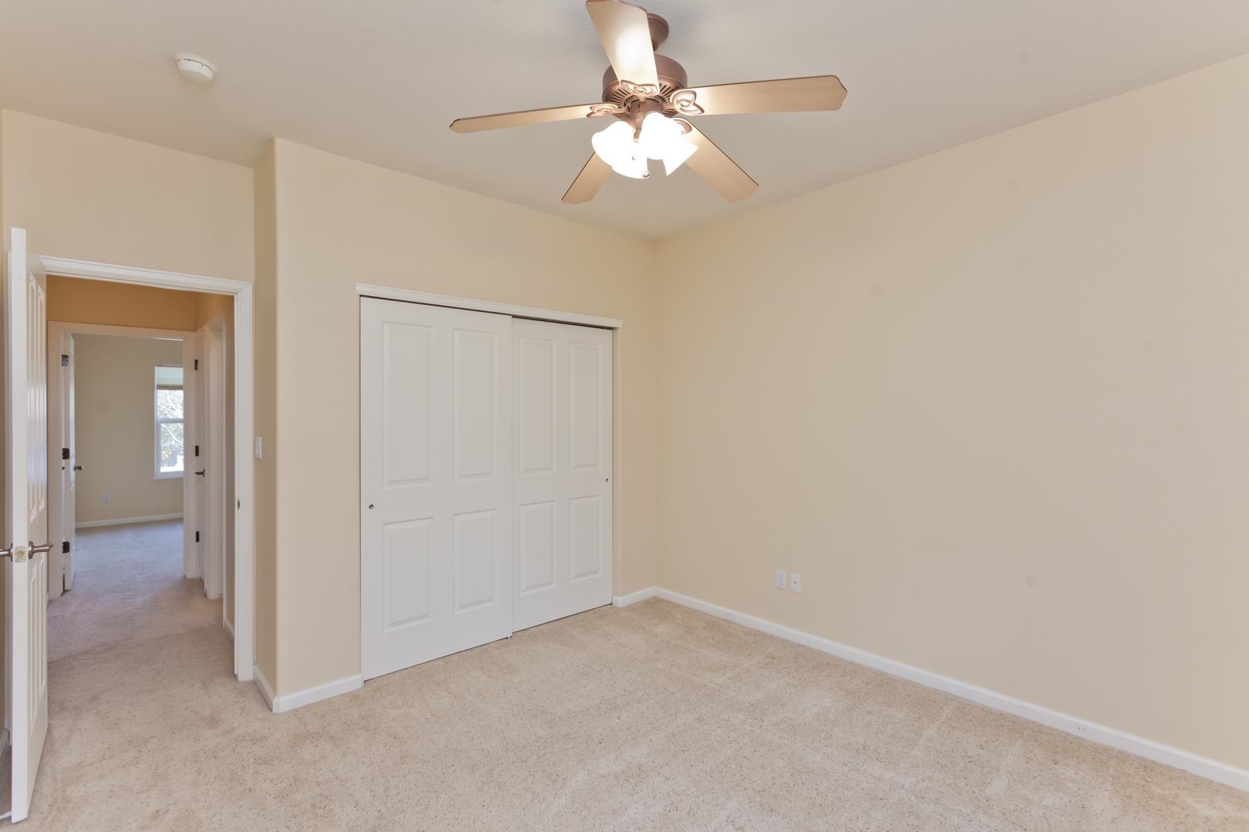 2433 Jack Creek Road Grand Junction, CO 81505 - Photo 27 of 41 an empty room with a ceiling fan and a fan