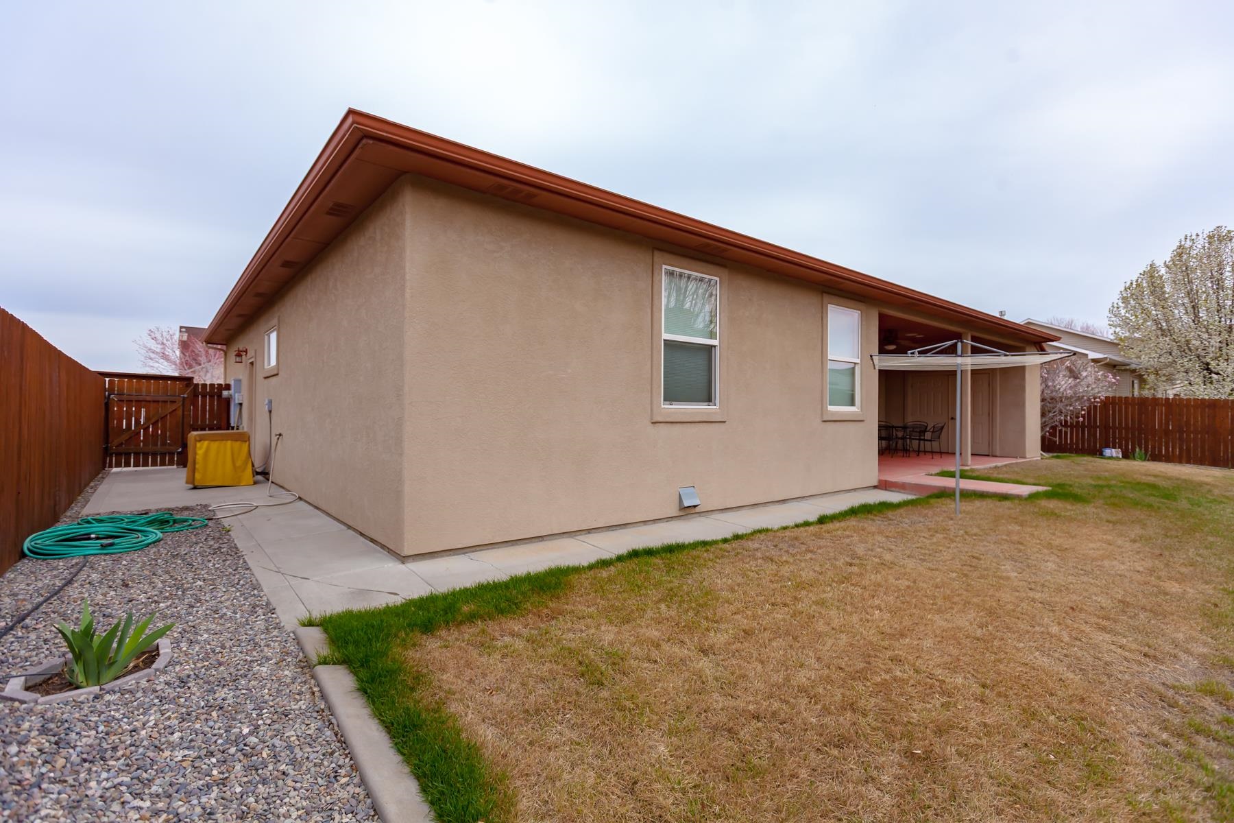 2433 Jack Creek Road Grand Junction, CO 81505 - Photo 36 of 41 a backyard of a house with garage and a tree