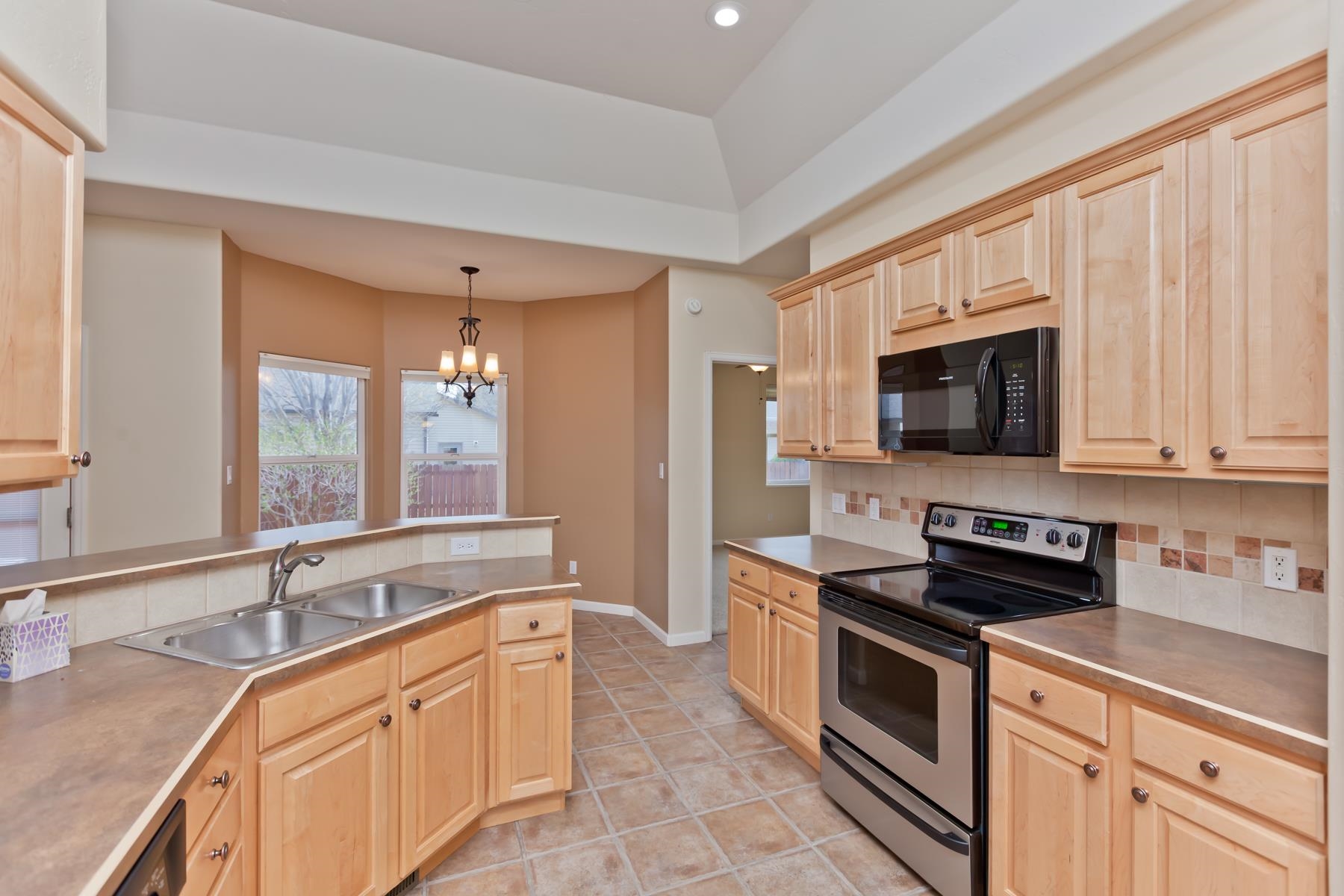 2433 Jack Creek Road Grand Junction, CO 81505 - Photo 5 of 41 a kitchen with stainless steel appliances granite countertop a sink and a stove