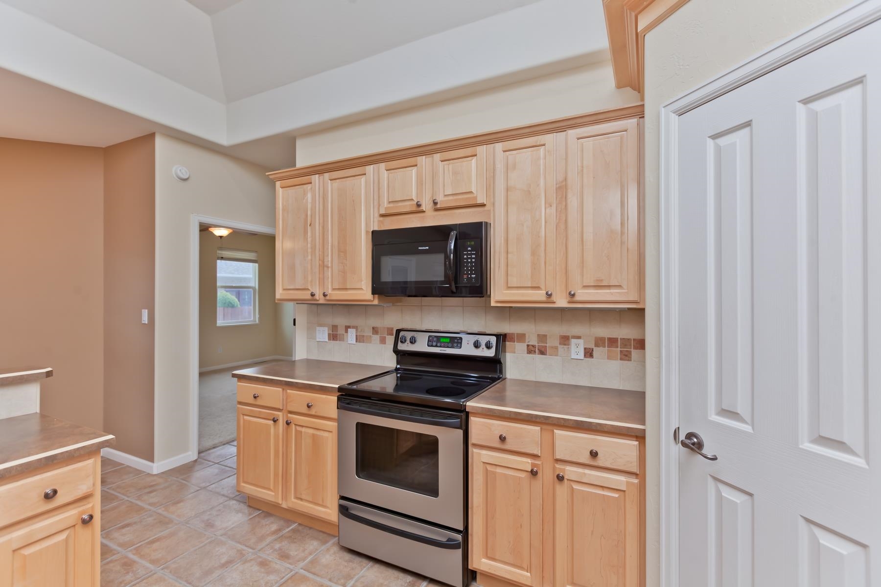 2433 Jack Creek Road Grand Junction, CO 81505 - Photo 6 of 41 a kitchen with white cabinets and stainless steel appliances