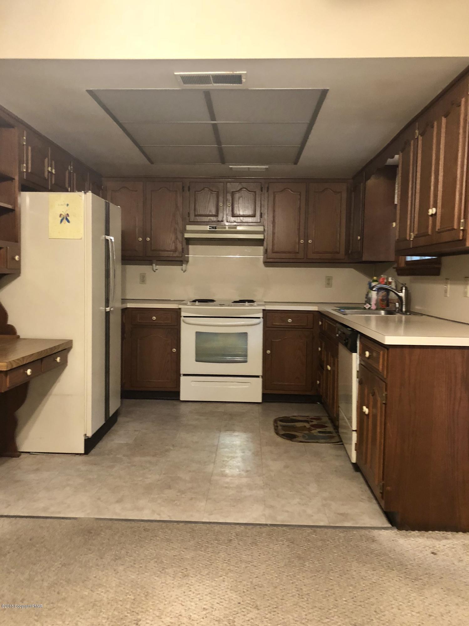 322 Charles Folly Road Bartonsville, PA 18321 - Photo 12 of 25 a kitchen with a sink stove and refrigerator