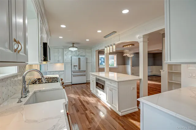 a spacious bathroom with a granite countertop sink a toilet and a shower