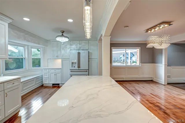 a bathroom with a sink mirror and a shower