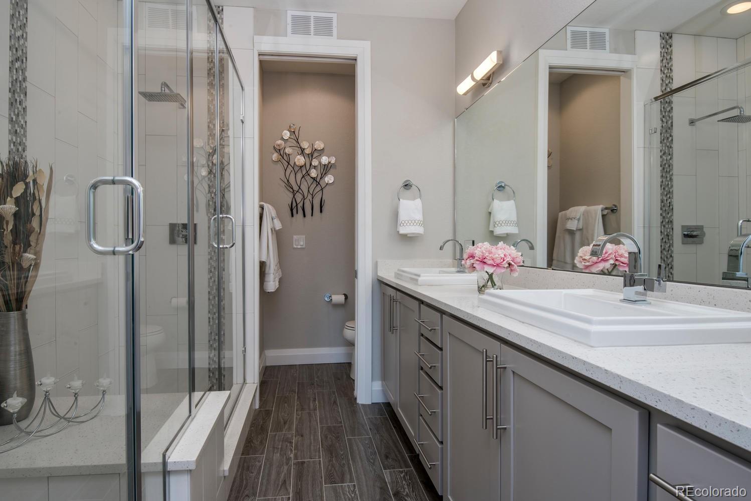 1571 Wolff Street Denver, CO 80204 - Photo 16 of 27 a bathroom with a double vanity sink mirror and shower