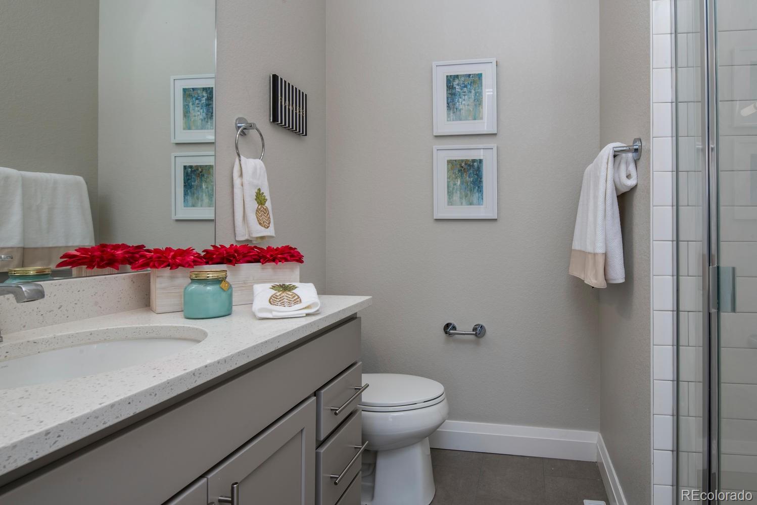 1571 Wolff Street Denver, CO 80204 - Photo 19 of 27 a bathroom with a sink vanity mirror and toilet