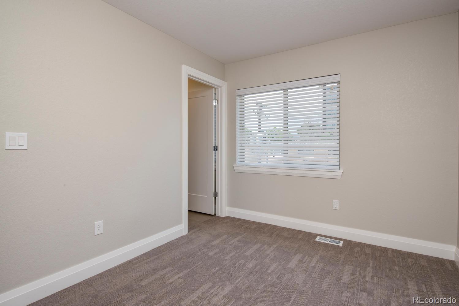 1571 Wolff Street Denver, CO 80204 - Photo 21 of 27 an empty room with wooden floor and windows