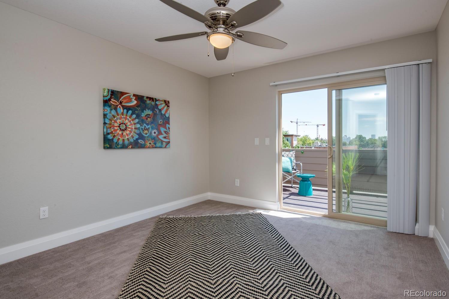 1571 Wolff Street Denver, CO 80204 - Photo 23 of 27 a view of an empty room with a window and a chandelier fan